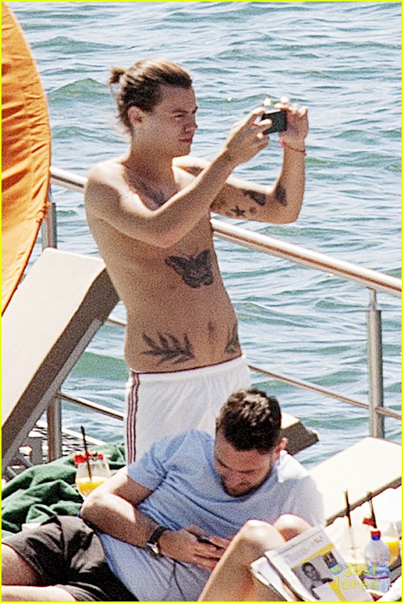 Harry Styles Rocks a Ponytail While Lounging Shirtless Poolside in Italy