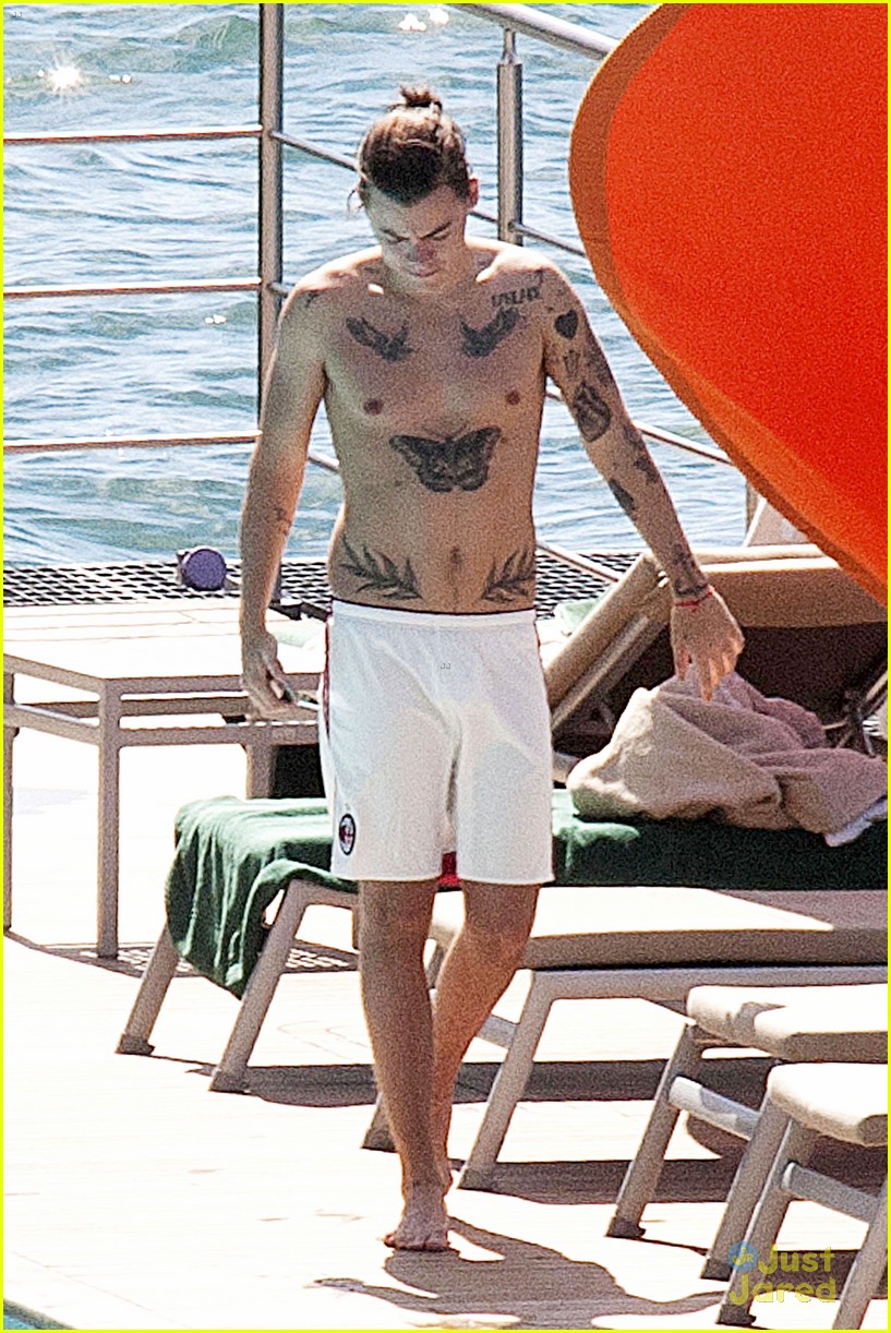 Harry Styles Rocks a Ponytail While Lounging Shirtless Poolside in Italy