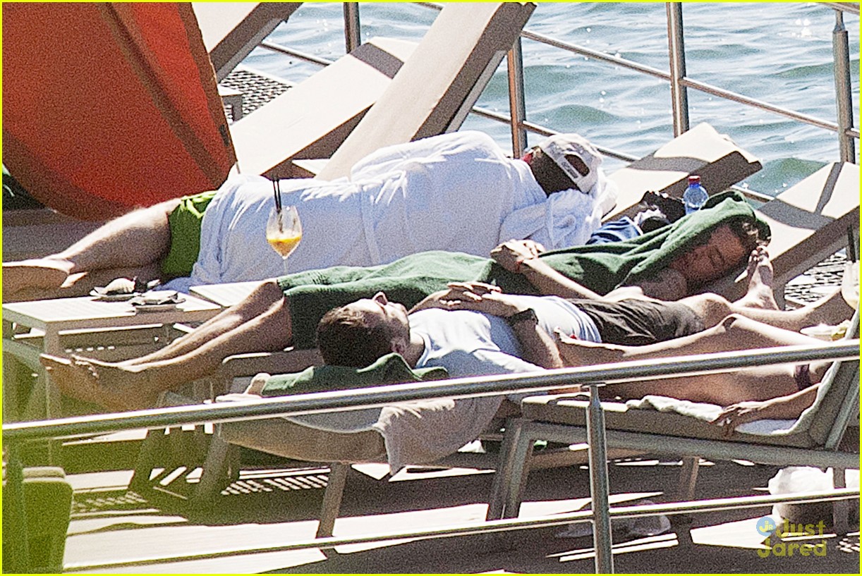 Harry Styles Rocks a Ponytail While Lounging Shirtless Poolside in Italy