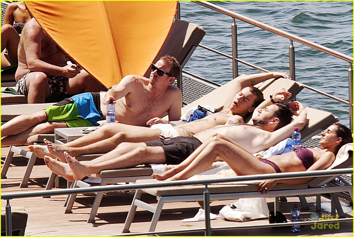 Harry Styles Rocks a Ponytail While Lounging Shirtless Poolside in Italy