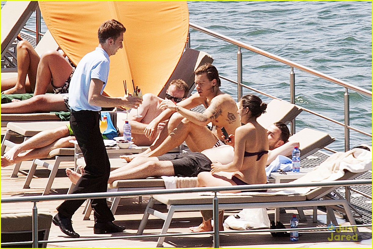 Harry Styles Rocks a Ponytail While Lounging Shirtless Poolside in Italy