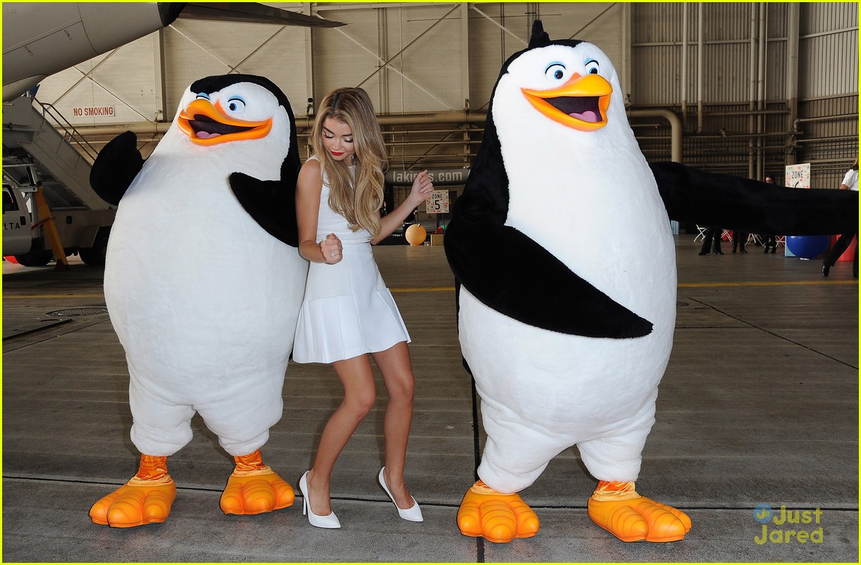 Sarah Hyland Dances With The Penguins Of Madagascar at Delta's Holiday In The Hangar