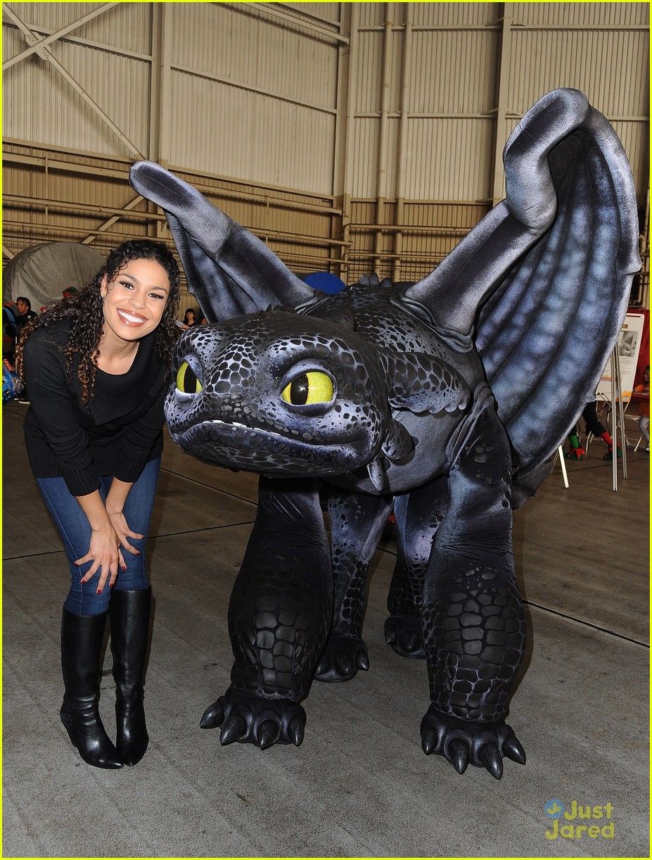 Sarah Hyland Dances With The Penguins Of Madagascar at Delta's Holiday In The Hangar