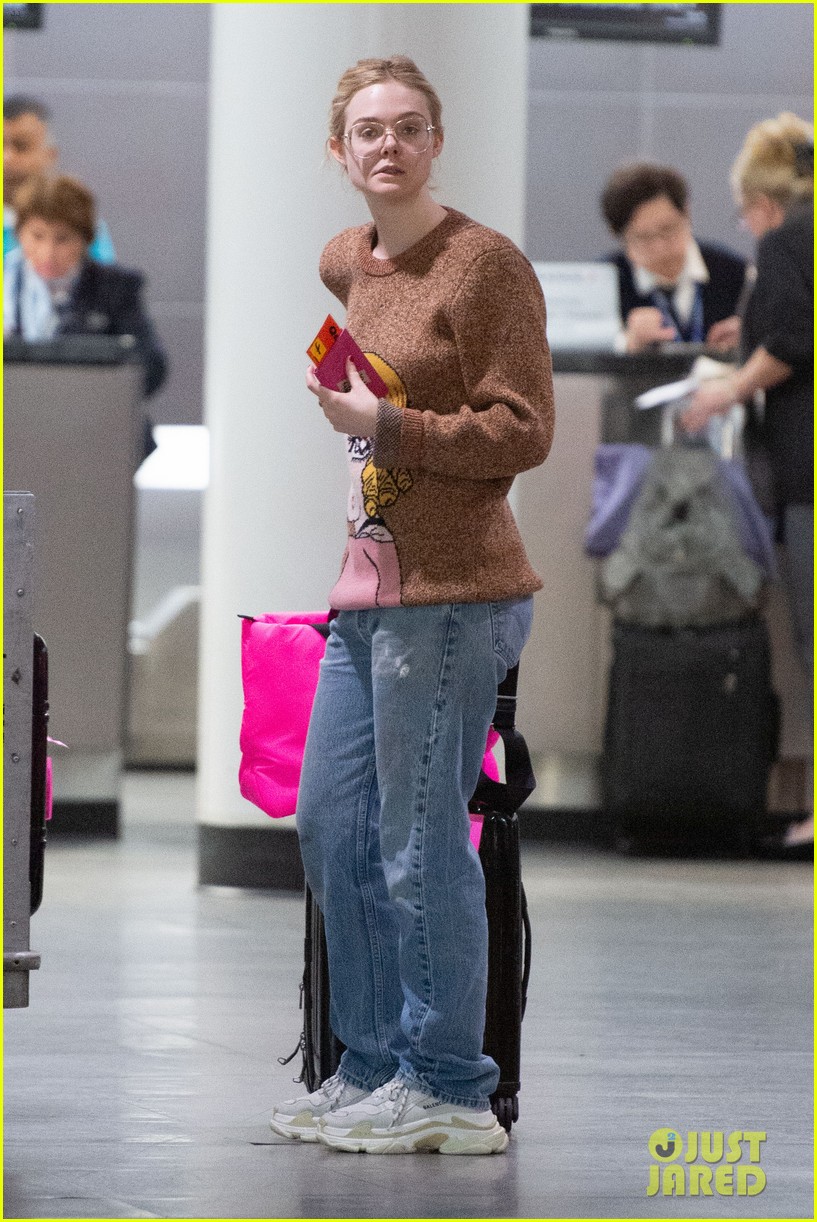 Elle Fanning Flashes a Grin While Landing in NYC After Paris Fashion Week