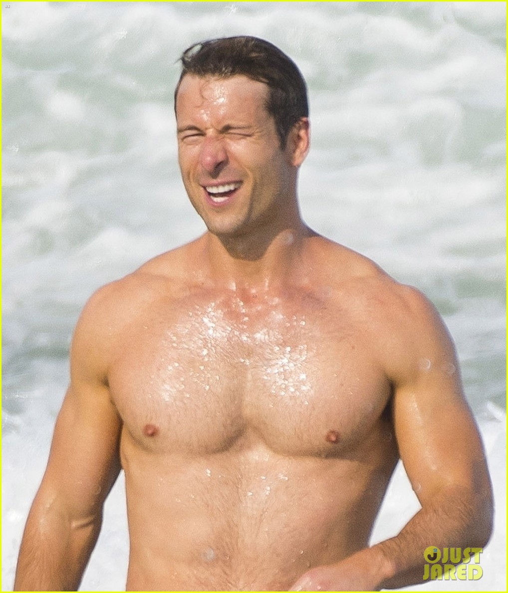 Sydney Sweeney Hits the Beach in White Bikini for Rom-Com Beach Scene with Glen Powell (Photos)