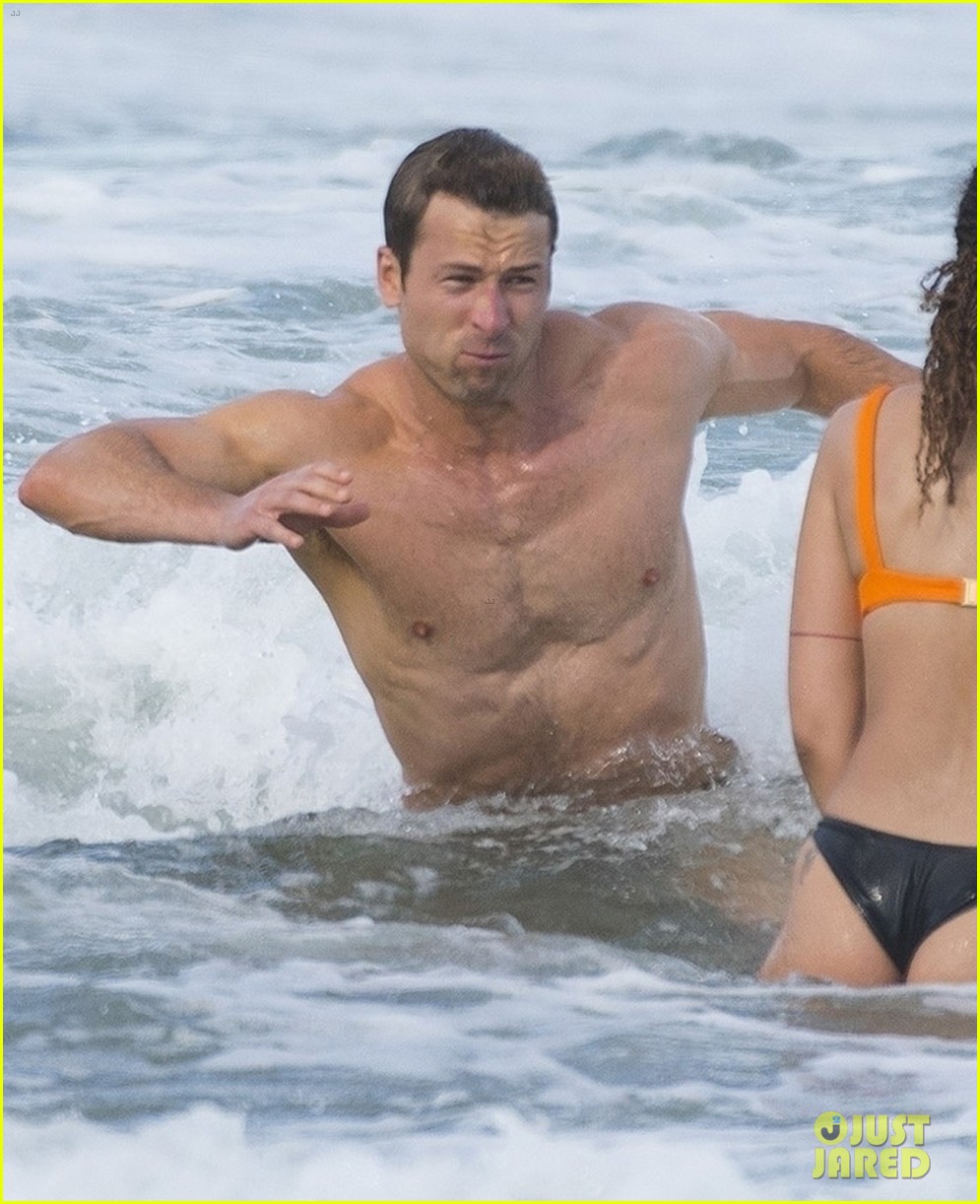 Sydney Sweeney Hits the Beach in White Bikini for Rom-Com Beach Scene with Glen Powell (Photos)