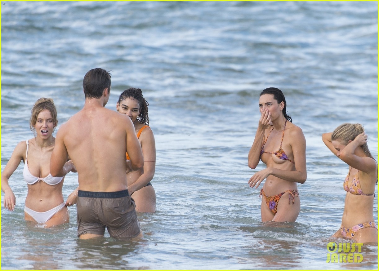 Sydney Sweeney Hits the Beach in White Bikini for Rom-Com Beach Scene with Glen Powell (Photos)