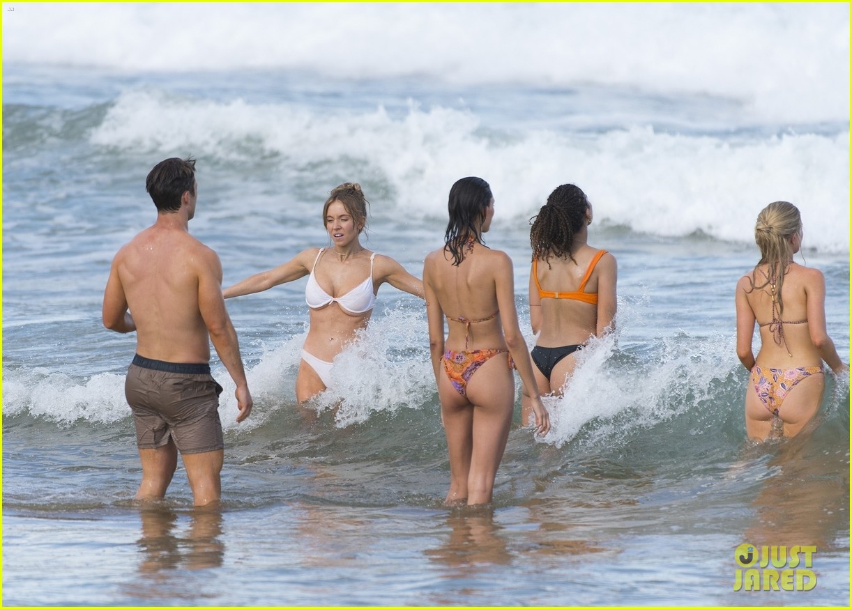 Sydney Sweeney Hits the Beach in White Bikini for Rom-Com Beach Scene with Glen Powell (Photos)